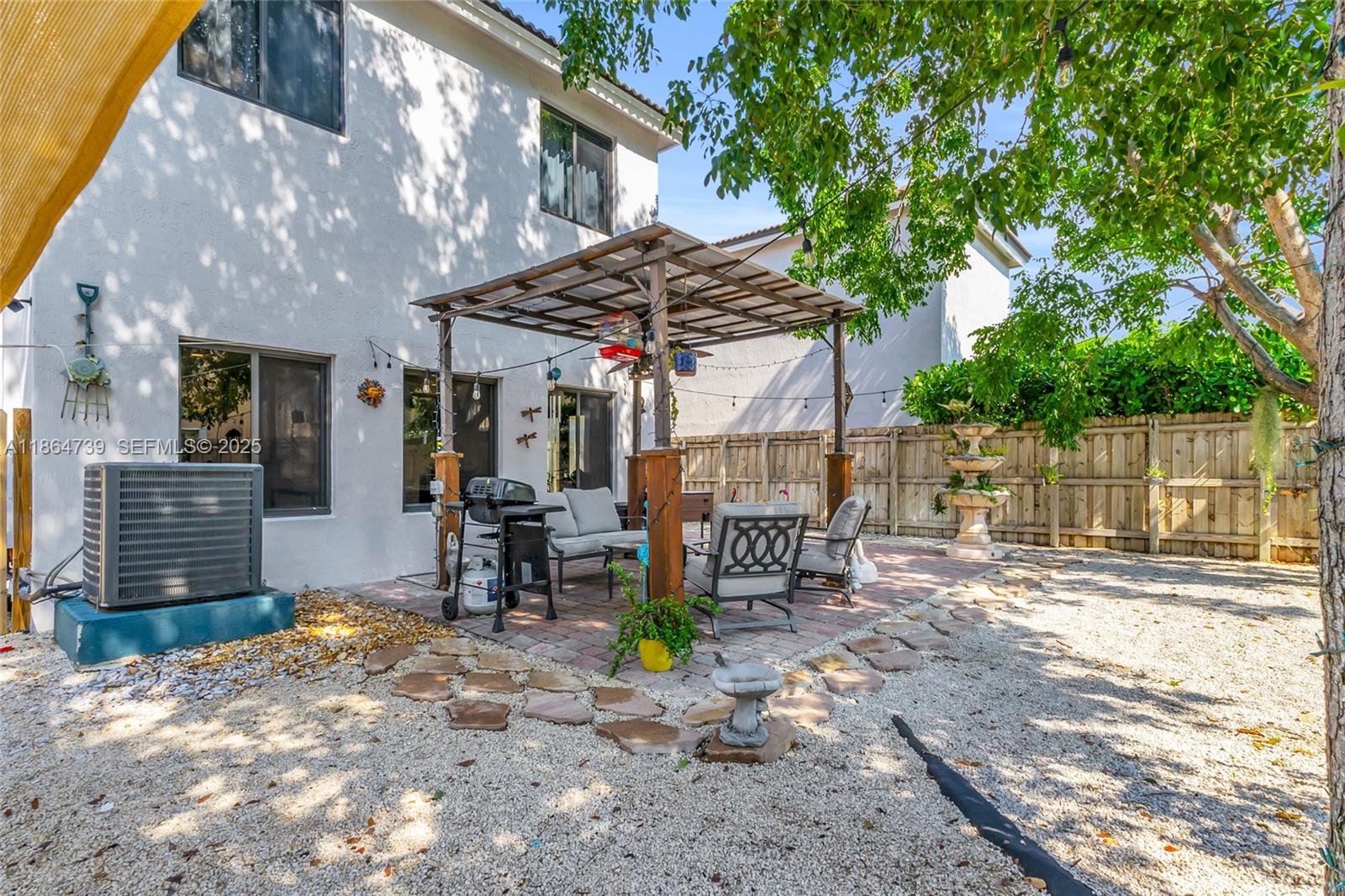 1635 Southeast 20th Terrace Homestead, FL 33035 - Photo 48 of 52 a view of a chairs and table in backyard