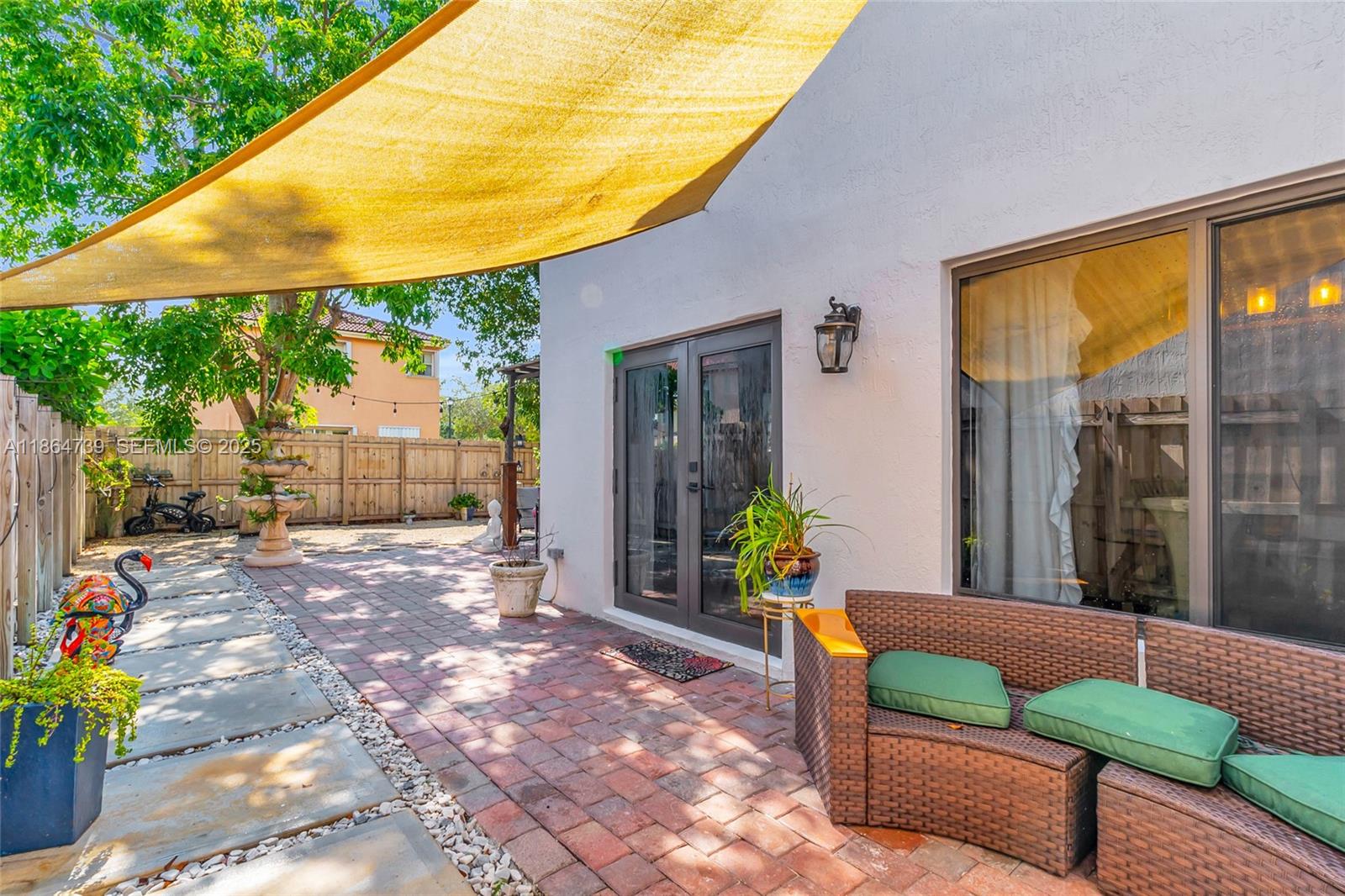 1635 Southeast 20th Terrace Homestead, FL 33035 - Photo 49 of 52 a backyard of a house with fountain table and chairs