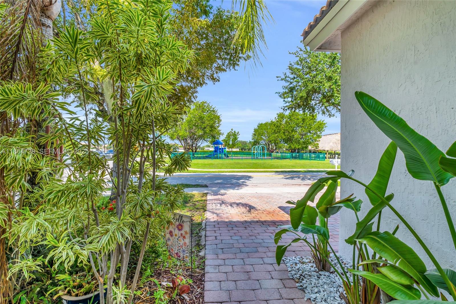 1635 Southeast 20th Terrace Homestead, FL 33035 - Photo 5 of 52 a view of a yard with plants in front of main door