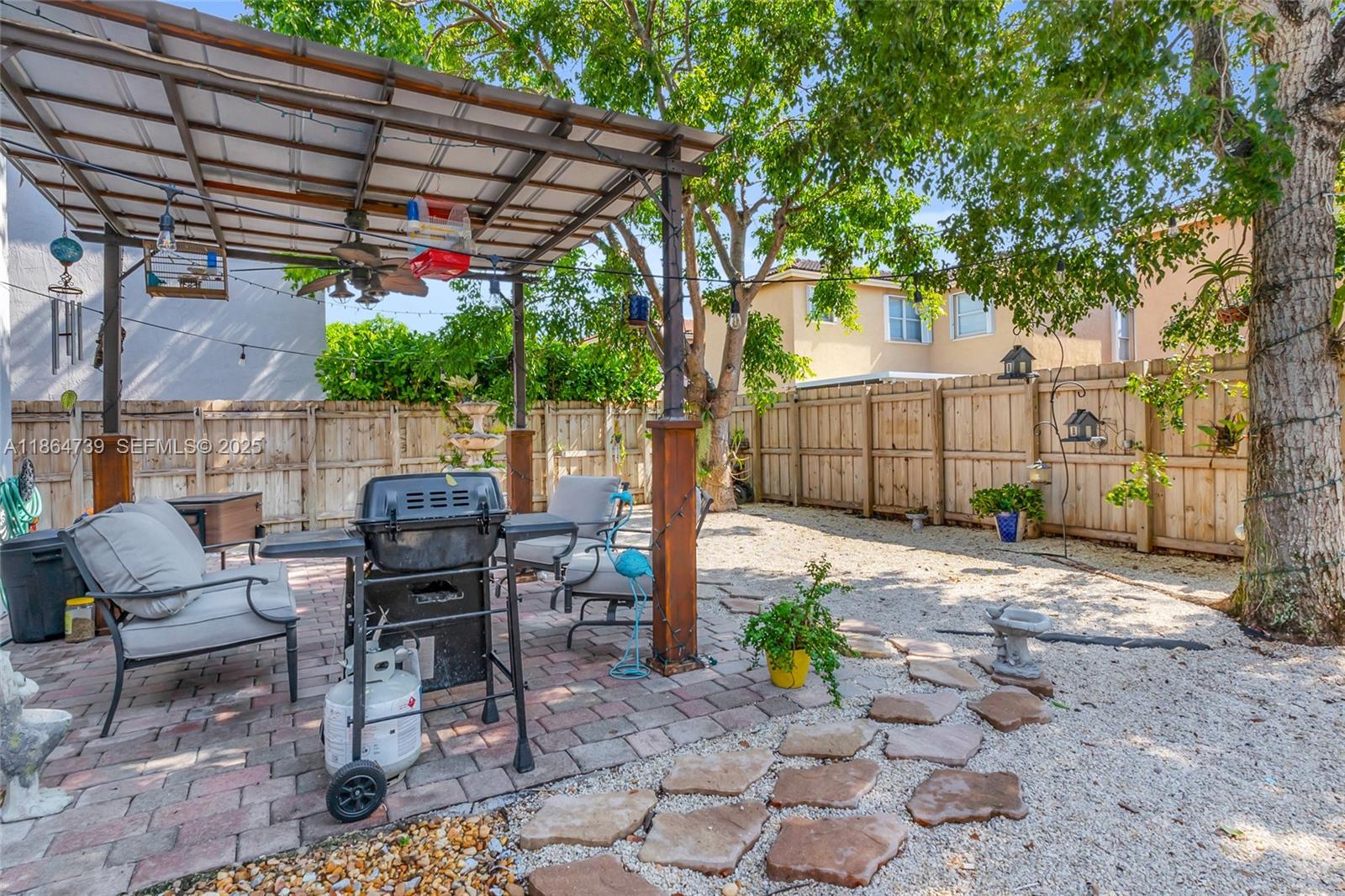 1635 Southeast 20th Terrace Homestead, FL 33035 - Photo 51 of 52 a view of a patio with table and chairs and potted plants