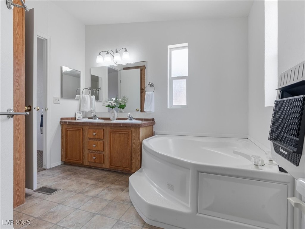 70 West Bonanza Road Las Vegas, NV 89124 - Photo 30 of 71 Full bath featuring double vanity and a bath