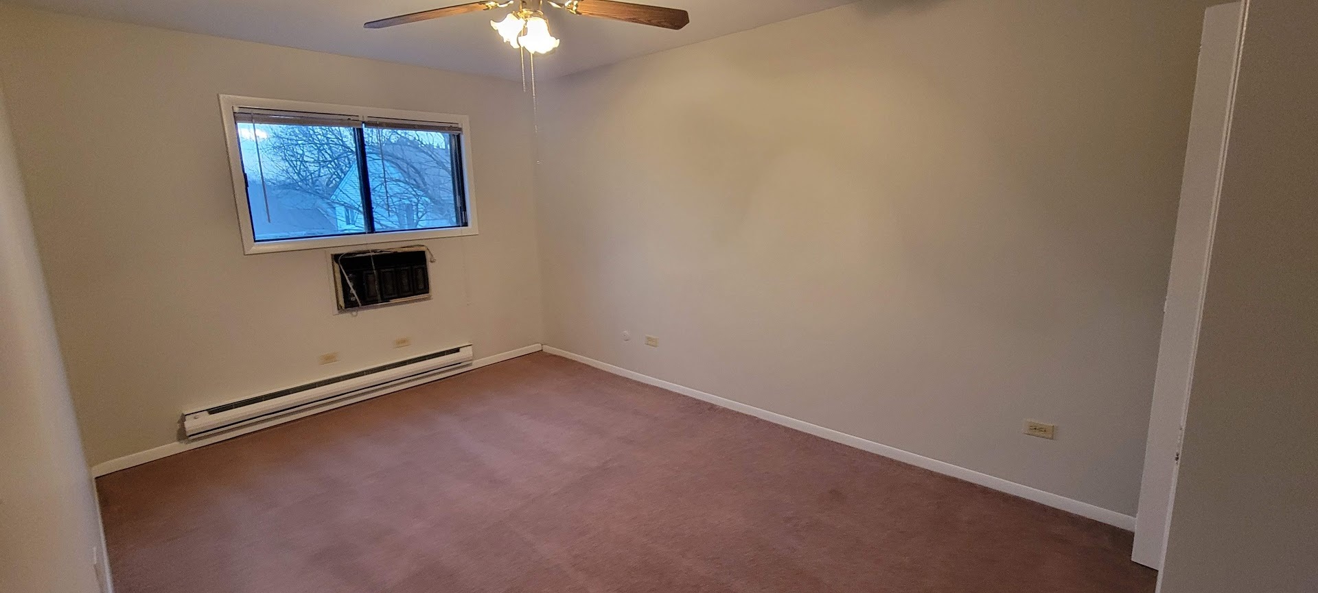 1832 Goodwin Drive, Unit 3A Palatine, IL 60074 - Photo 6 of 9 an empty room with windows and fan
