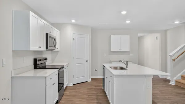 a view of a storage and utility room with wooden floor