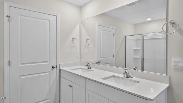 a bathroom with a sink double vanity and a mirror