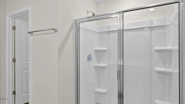 a bathroom that has a glass shower door