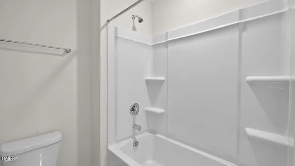 a bathroom with a bathtub and a toilet