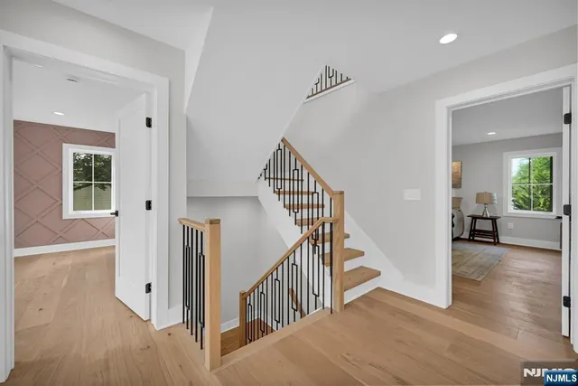 a view of a hallway with wooden floor and entryway