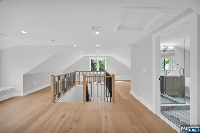a view of a hallway with wooden floor and dining room