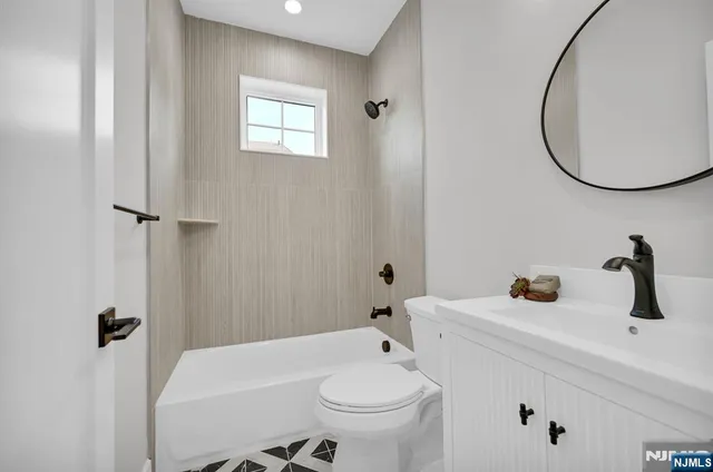 a bathroom with a sink a toilet and a mirror