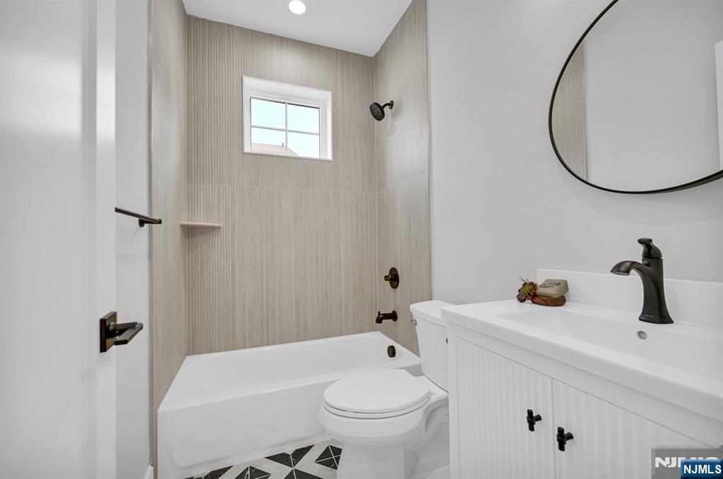 46 Snyder Avenue Berkeley Heights, NJ 07922 - Photo 5 of 38 a bathroom with a sink a toilet and a mirror