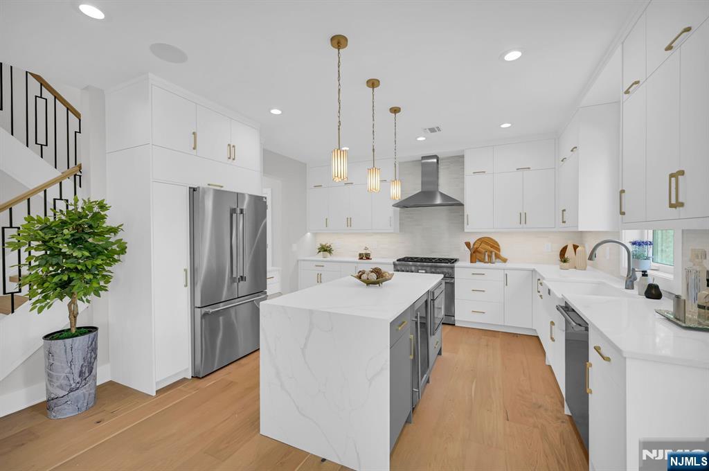 46 Snyder Avenue Berkeley Heights, NJ 07922 - Photo 10 of 38 a kitchen with stainless steel appliances a refrigerator sink and wooden floor