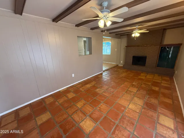 a view of an empty room with a fireplace
