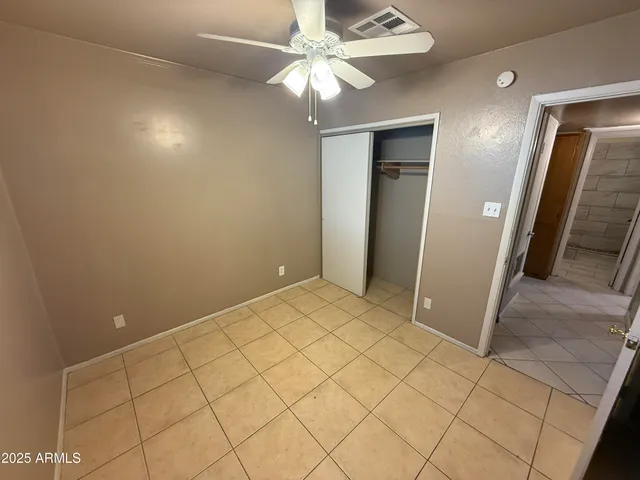 a view of a livingroom with a chandelier fan