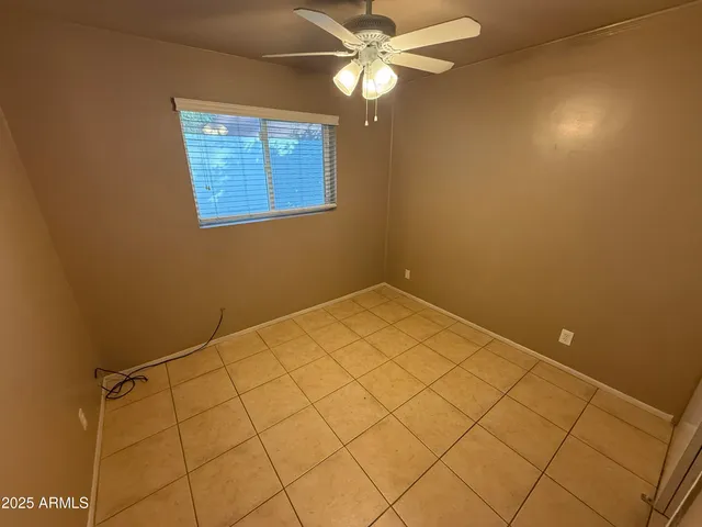 a view of a room with window and ceiling fan