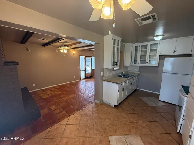 a kitchen with granite countertop a stove a refrigerator and a microwave