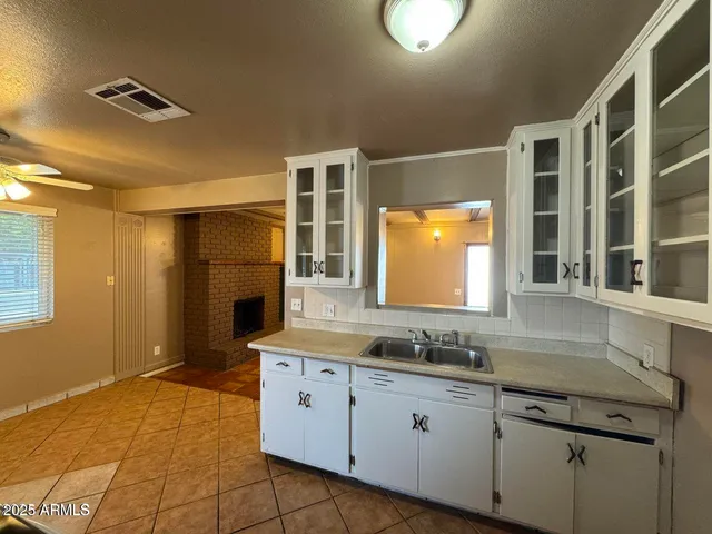 a bathroom with a granite countertop sink mirror and double