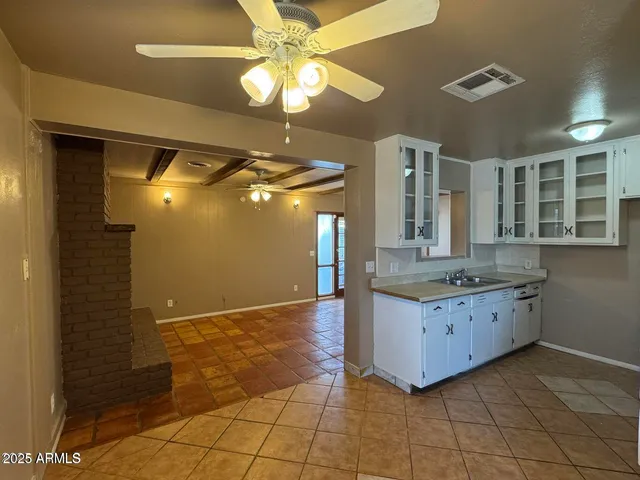 a bathroom with a granite countertop sink a mirror and a shower