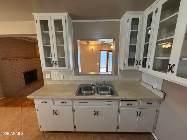 a bathroom with a granite countertop sink a mirror and a shower