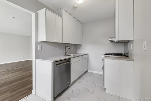 a kitchen with granite countertop white cabinets and white appliances