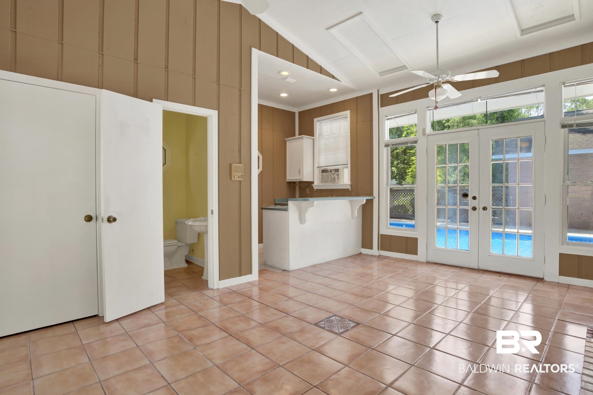 6805 Hunters Court Mobile, AL 36695 - Photo 34 of 37 Kitchen with french doors, light tile patterned flooring, a ceiling fan, high vaulted ceiling, and a kitchen bar