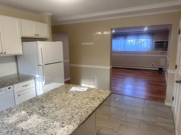 a kitchen with granite countertop a refrigerator and a stove