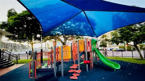a park with lots of trees and chairs