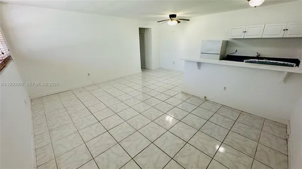 a kitchen with white cabinets and white appliances