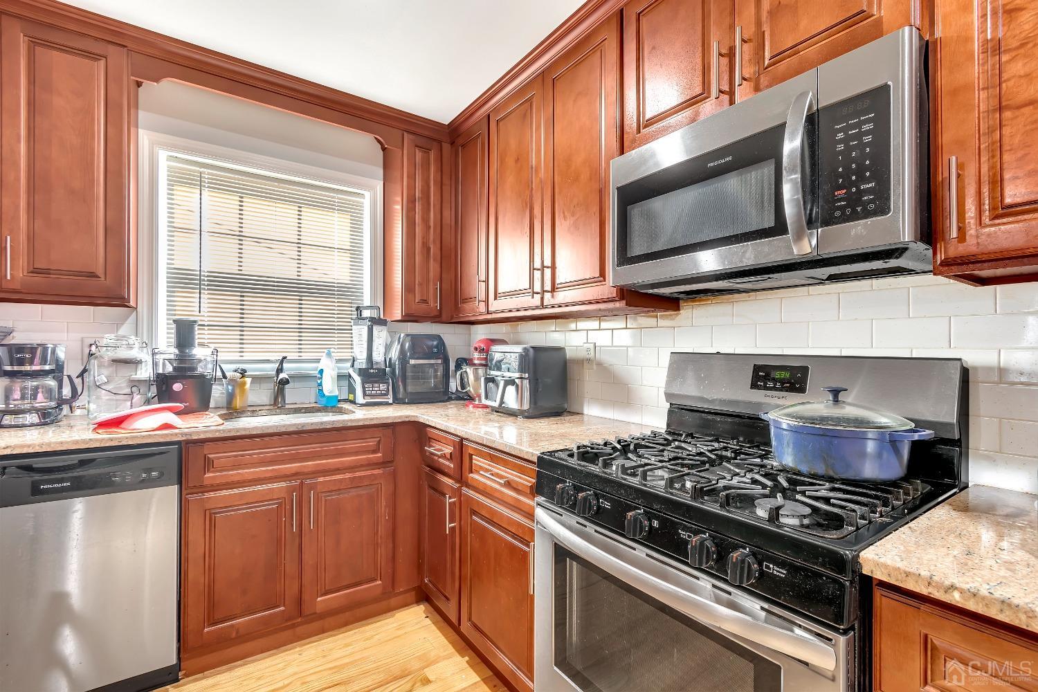 B Wright Place New Brunswick, NJ 08901 - Photo 12 of 34 a kitchen with stainless steel appliances granite countertop a sink stove and microwave