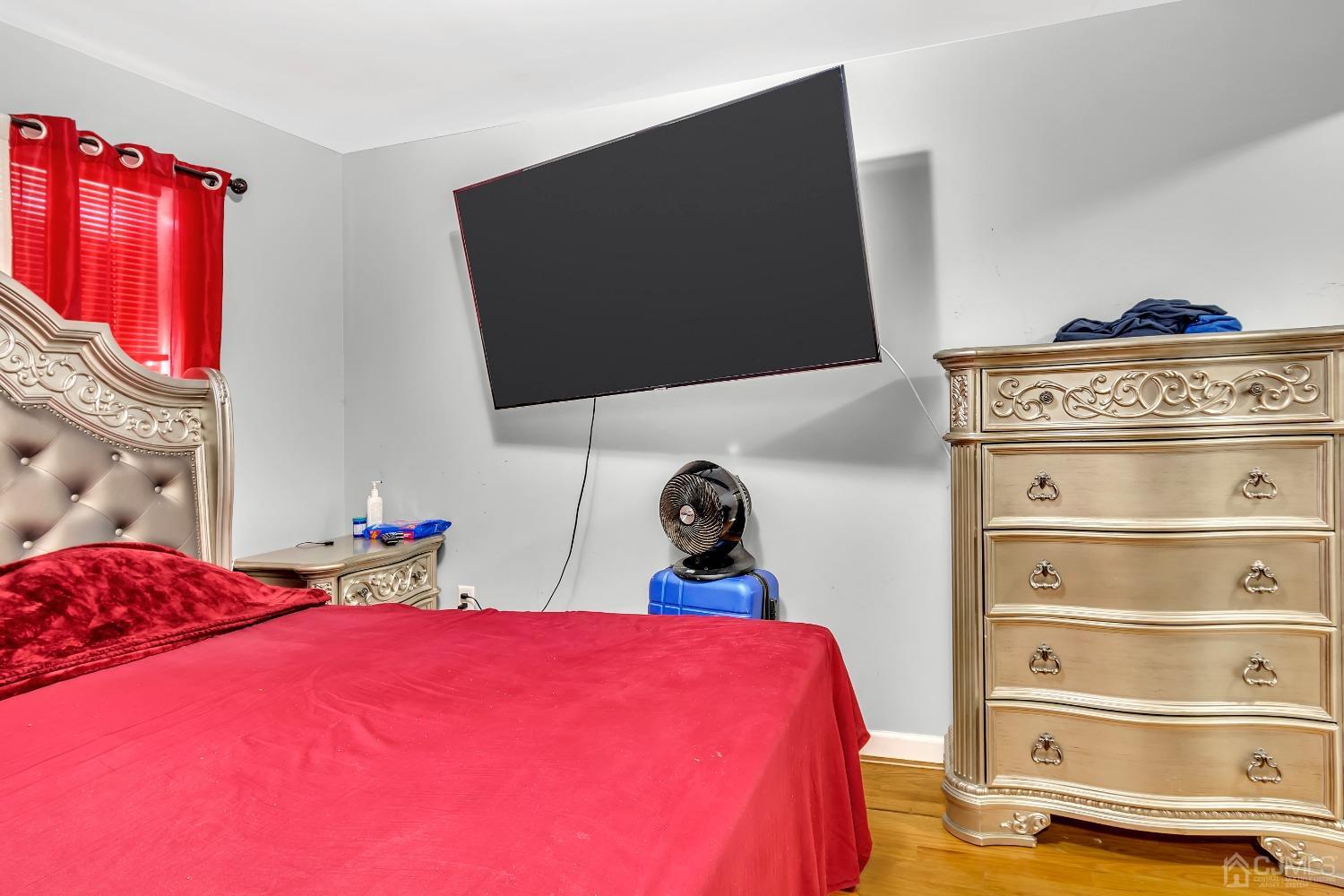 B Wright Place New Brunswick, NJ 08901 - Photo 19 of 34 a bedroom with a bed and flat screen tv