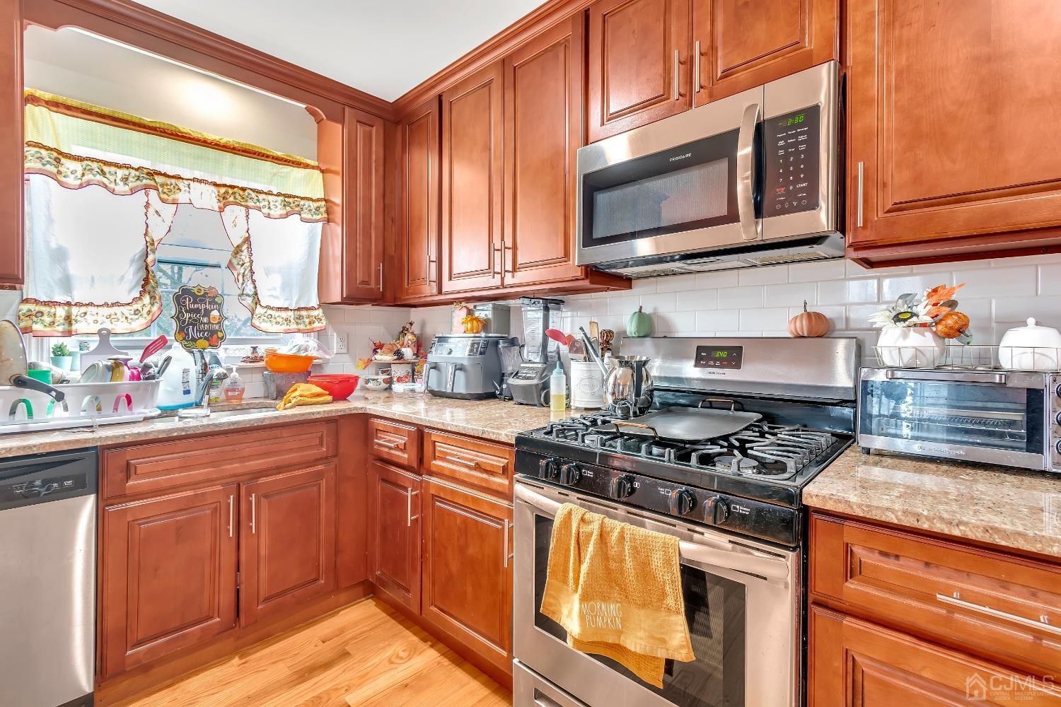 B Wright Place New Brunswick, NJ 08901 - Photo 27 of 34 a kitchen with stainless steel appliances granite countertop a stove a sink and a microwave