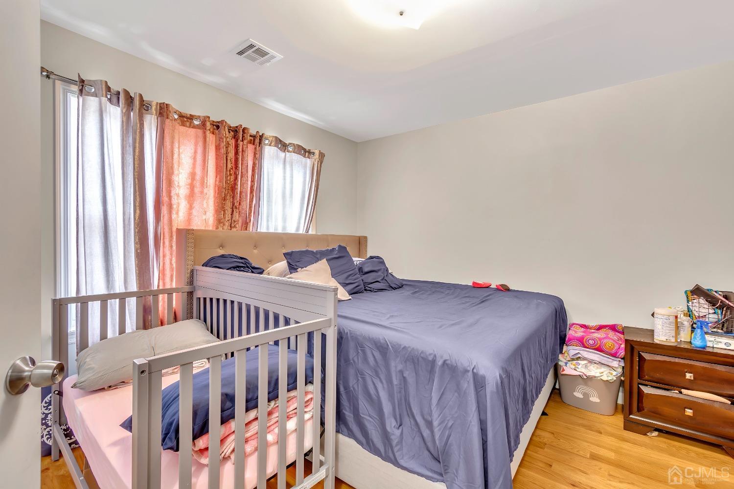 B Wright Place New Brunswick, NJ 08901 - Photo 31 of 34 a bedroom with three beds and a window