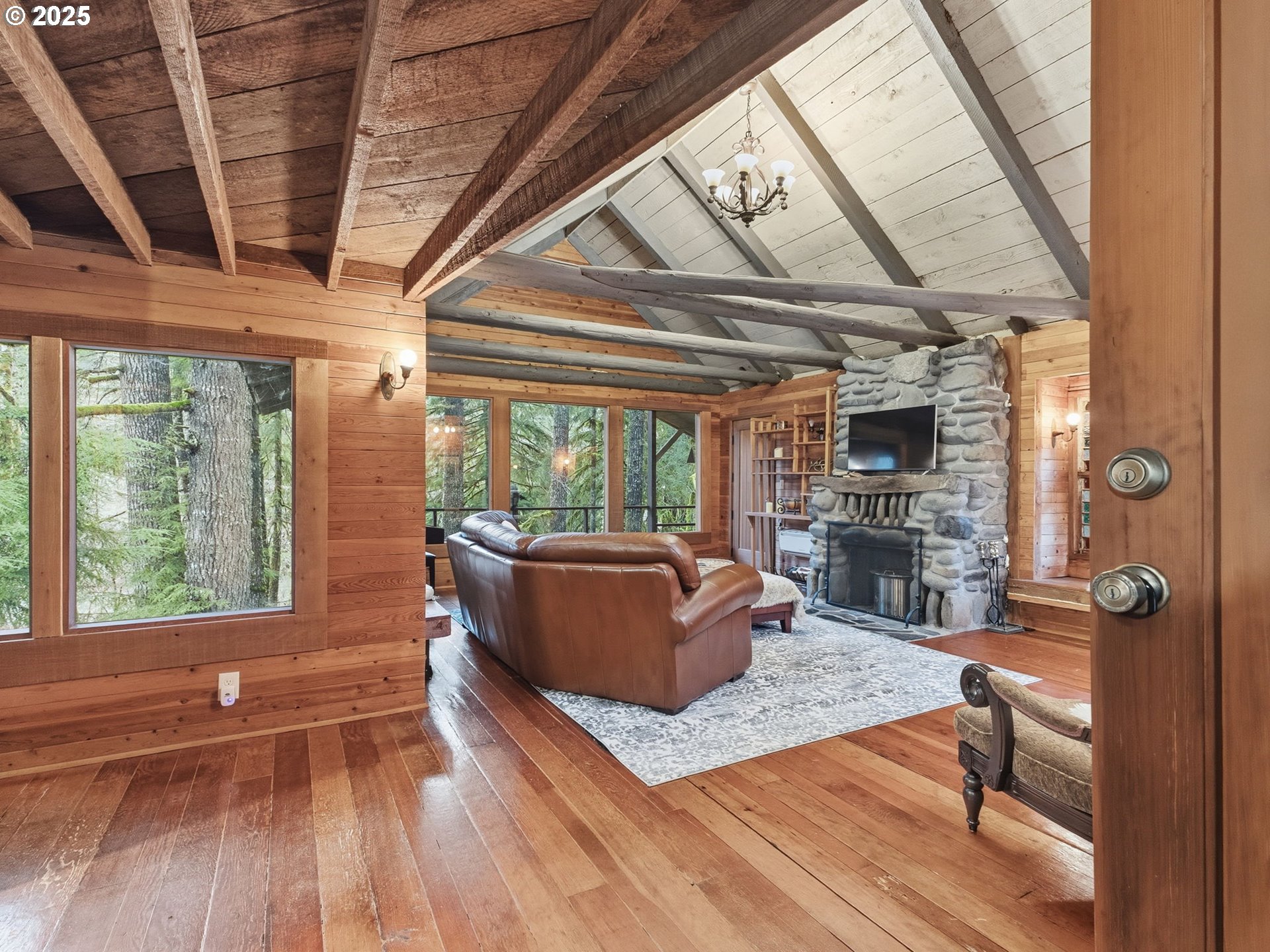 78506 Highway 53 Nehalem, OR 97131 - Photo 17 of 48 a living room with furniture a fireplace and a floor to ceiling window