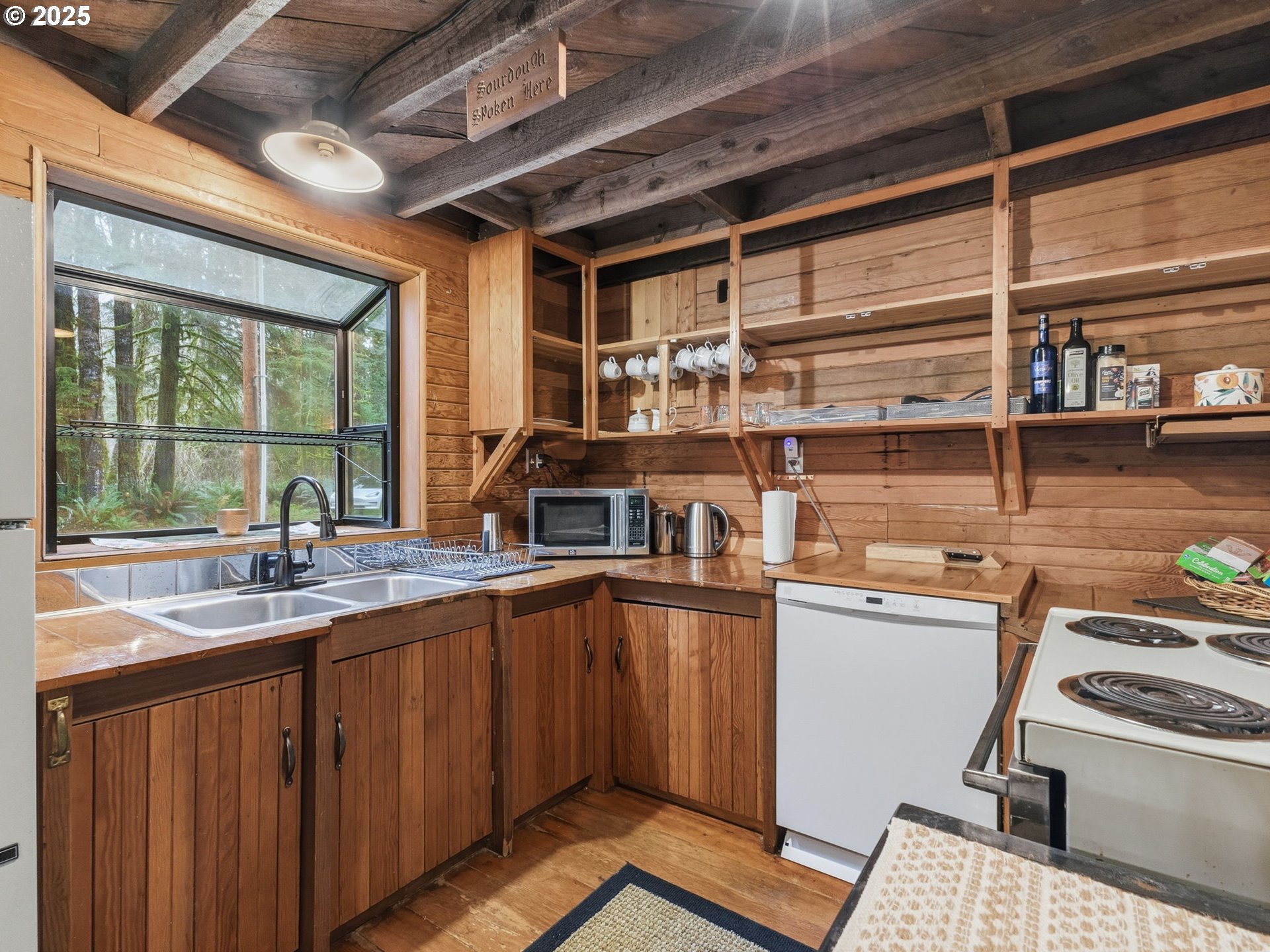 78506 Highway 53 Nehalem, OR 97131 - Photo 18 of 48 a kitchen with a sink and wooden cabinets