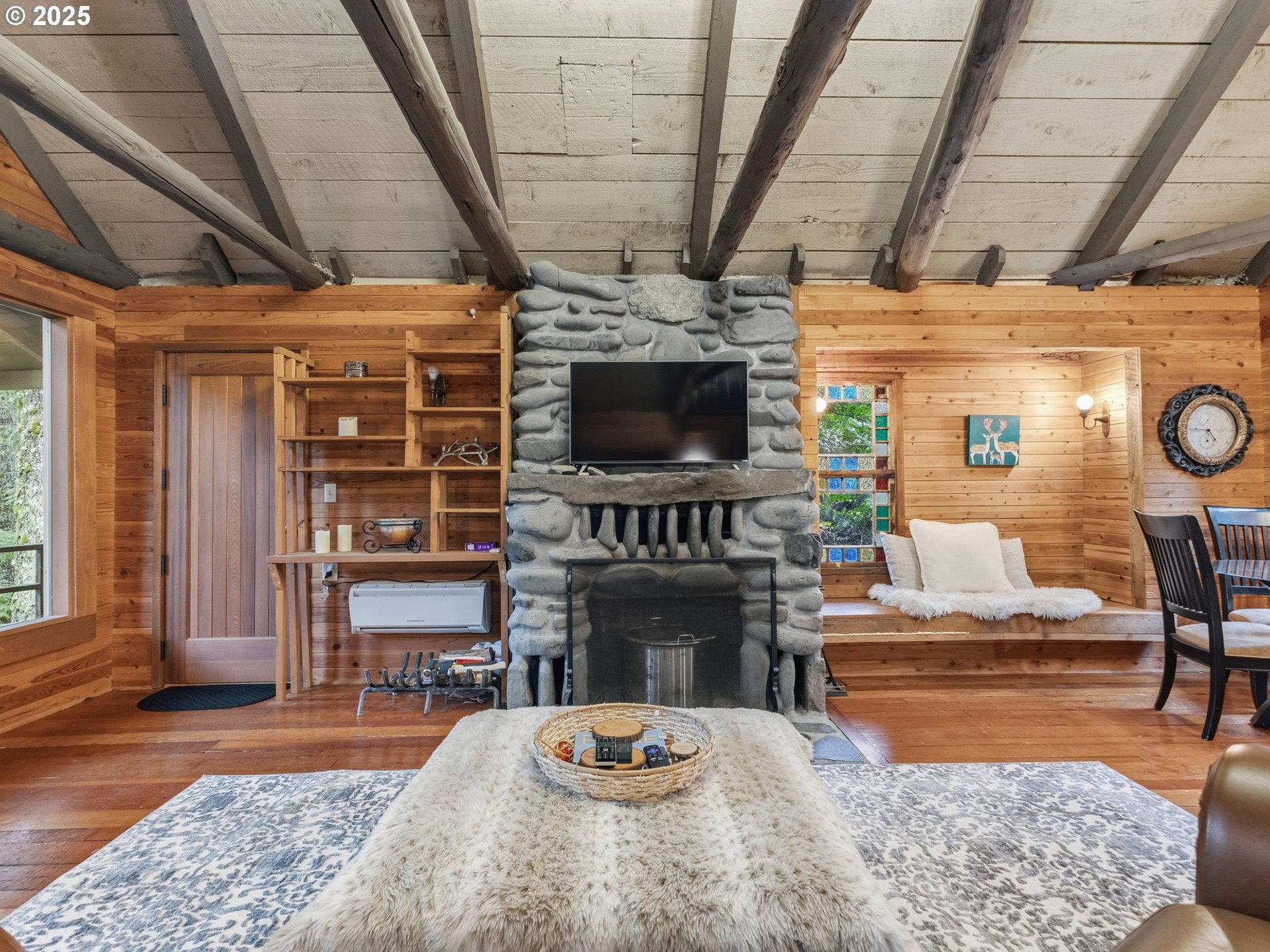 78506 Highway 53 Nehalem, OR 97131 - Photo 28 of 48 a living room with fireplace furniture a flat screen tv and a table