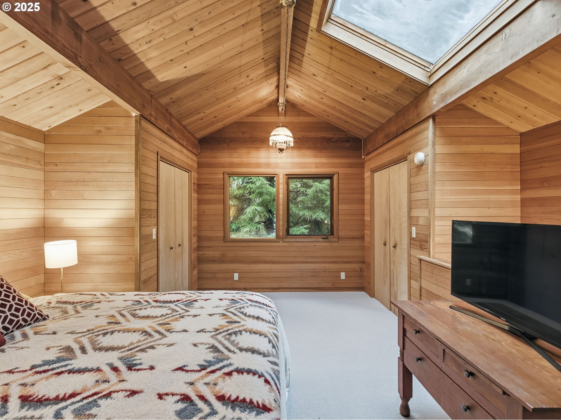 78506 Highway 53 Nehalem, OR 97131 - Photo 37 of 48 a bedroom with a bed and a flat screen tv