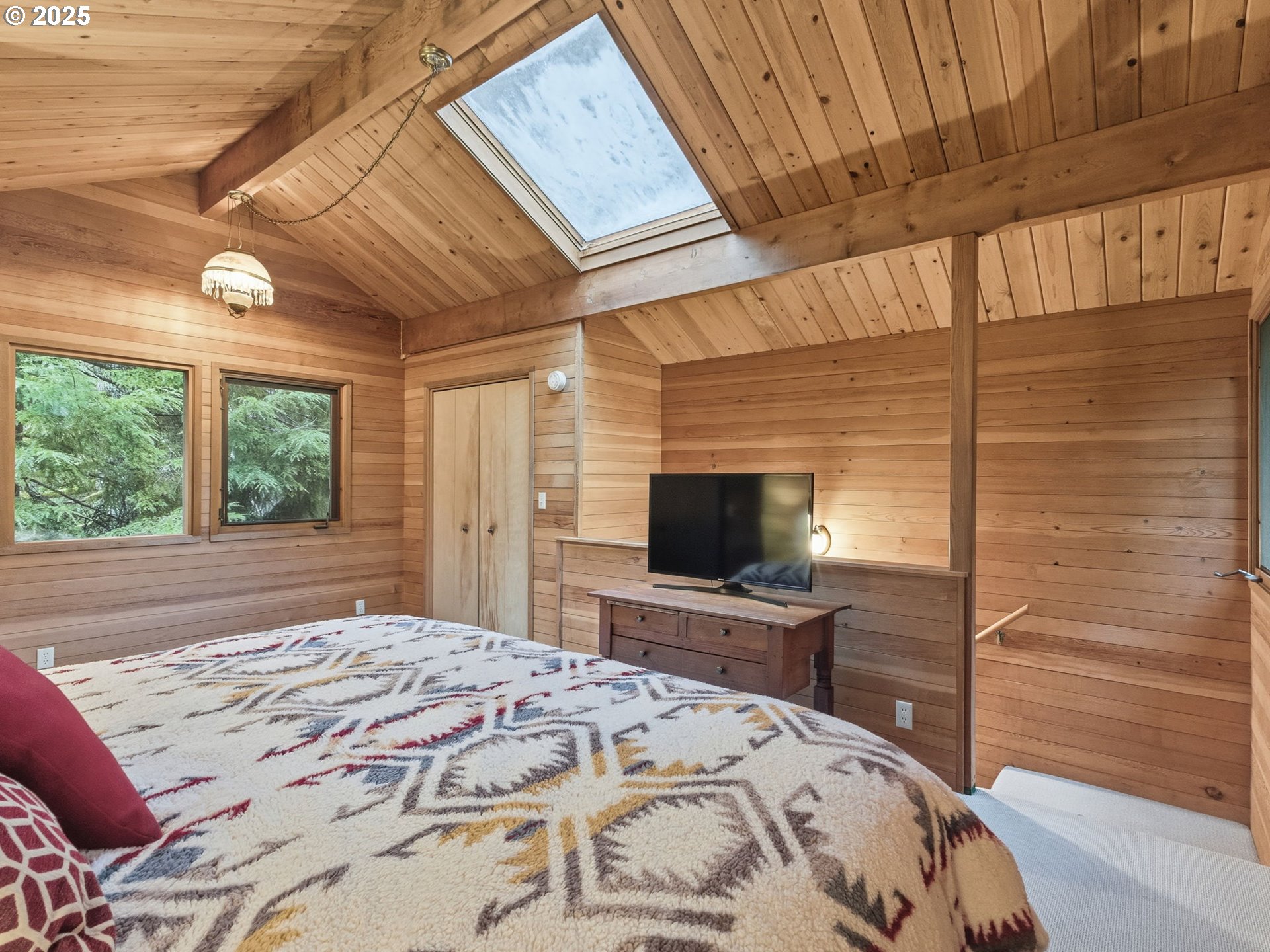 78506 Highway 53 Nehalem, OR 97131 - Photo 38 of 48 a bedroom with a bed and a flat screen tv