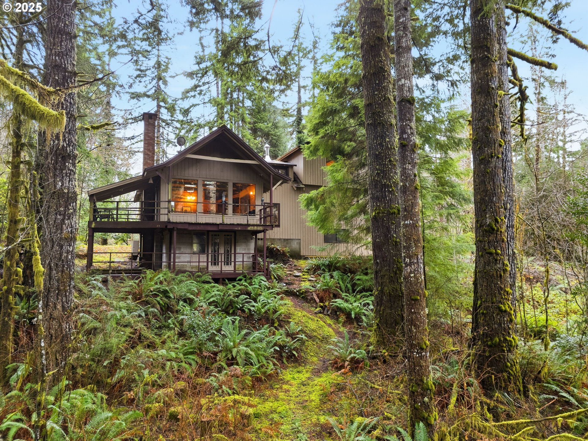 78506 Highway 53 Nehalem, OR 97131 - Photo 6 of 48 a front view of a house with a yard and fountain