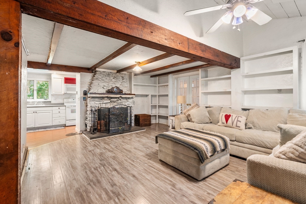 7 Victoria Avenue Rutland, MA 01543 - Photo 2 of 21 a spacious bedroom with a bed a fireplace and a large window with the outer view