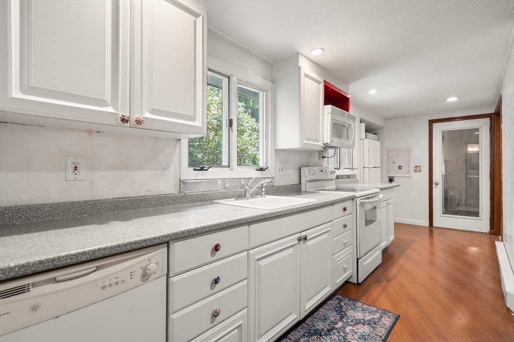7 Victoria Avenue Rutland, MA 01543 - Photo 5 of 21 a kitchen with granite countertop white cabinets and white appliances