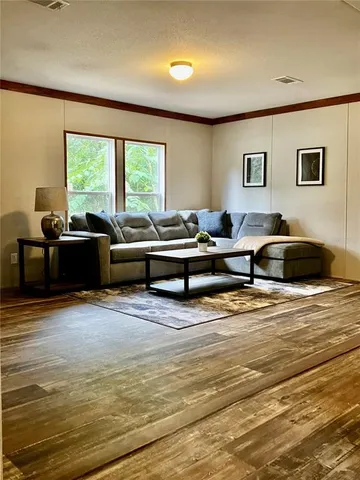 a living room with furniture and a large window