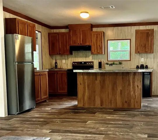 a kitchen with stainless steel appliances granite countertop a refrigerator stove and sink