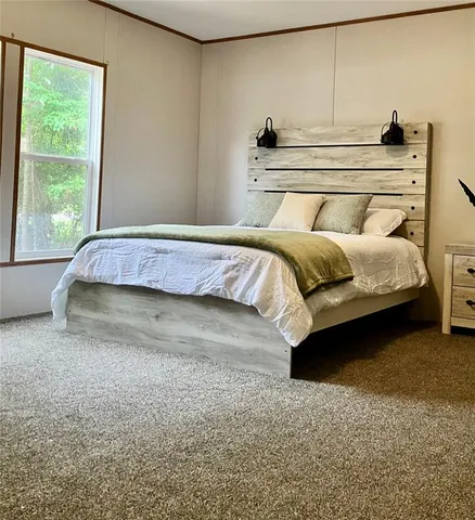 a bedroom with a bed and window