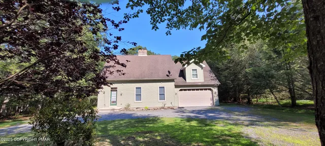 front view of a house with a tree