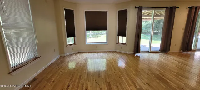 a view of a dining room with furniture window and wooden floor