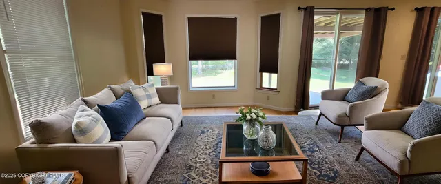 a view of room with window and flat screen tv