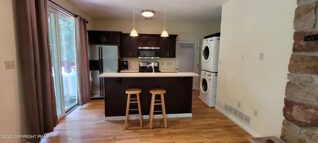 a view of livingroom with hardwood floor and a flat screen tv