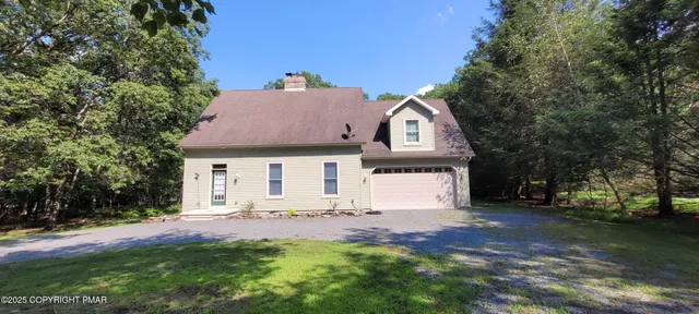 a view of a house with a yard and tree s