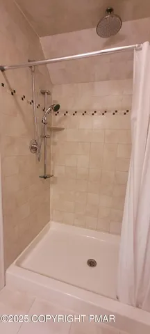 a bedroom with a bed and a television