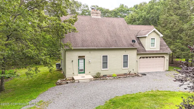a aerial view of a house with a yard and garage
