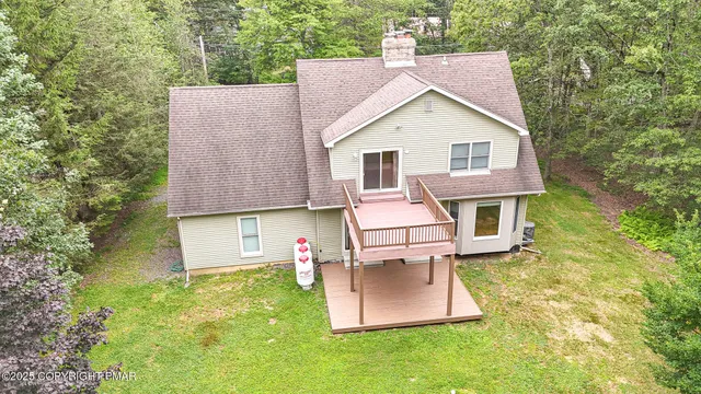 a aerial view of a house with table and chairs in patio